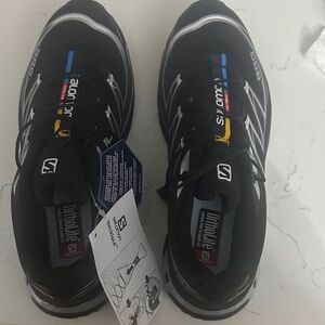 Salomon Black Athletic Trail Shoes with Blue and Yellow Accents